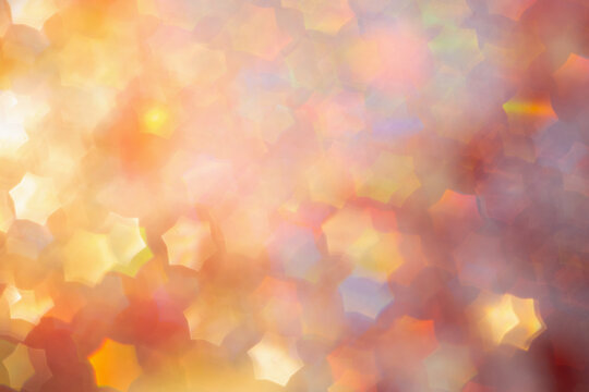 Abstract defocused multicolored background with shining glitter in stars form.Good as overlay layer.