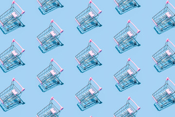 Pattern of supermarket shopping cart on pastel blue background. Creative design for packaging....