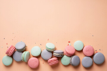 Pink, mint and lilac macarons cookies on a pink background.