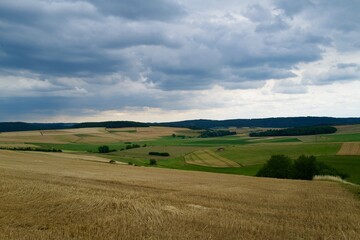 landscape with field and blue cloudy sky