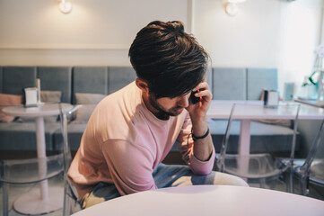 Man in pink sweater eat