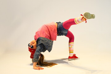 a little girl in a difficult breakdance position, unique girl