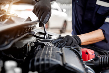 Car care maintenance and servicing, Close-up hand technician auto mechanic using the wrench to repairing change spare part car engine problem and insurance service support.