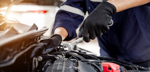 Car care maintenance and servicing, Close-up hand technician auto mechanic using the wrench to repairing change spare part car engine problem and insurance service support.