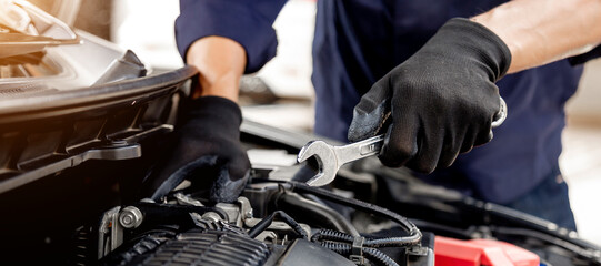 Car care maintenance and servicing, Close-up hand technician auto mechanic using the wrench to repairing change spare part car engine problem and insurance service support.