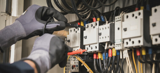 Electricity and electrical maintenance service, Engineer hand holding AC multimeter checking...