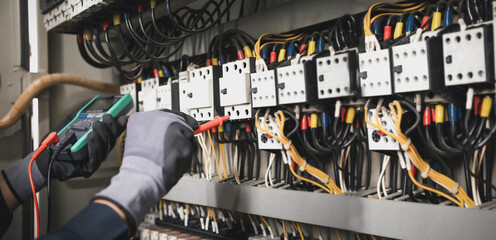 Electricity and electrical maintenance service, Engineer hand holding AC multimeter checking...