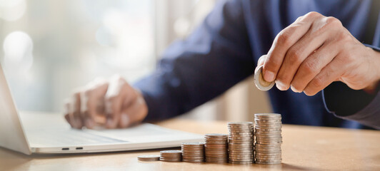Man hands putting coins stack, Concept business finance saving money and investment.