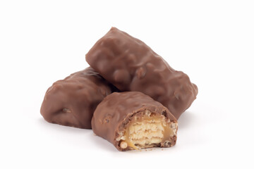 Crispy bits of chocolate bars. Chocolate bars with peanuts and caramel. Close up view.