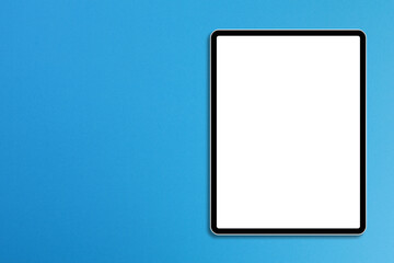 Modern digital tablet isolated on blue background with copy space