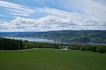 Landscape with mountains, river and buildings in Lillehammer town, Norway.