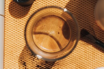 Close up top view of espresso coffee with beautiful crema in small glass.