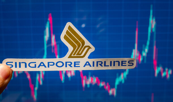 November 10, 2021, Singapore. The emblem of Singapore Airlines against the backdrop of a stock price chart.