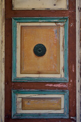 old wooden door painted red yellow and blue