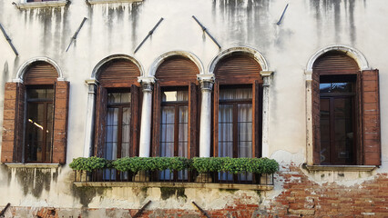 Fototapeta na wymiar windows of an old house country facade texture
