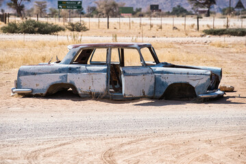 Abandoned rusty car wreck in the small village Solitaire in Namibia. Lonely, deserted, vintage...