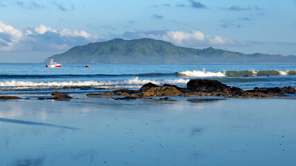 Sunrise on the beach in Tamarindo, Costa Rica, with mountains in the distance