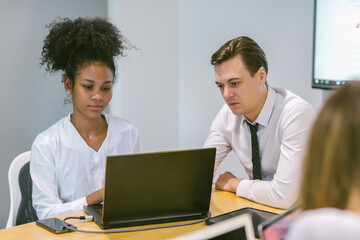 Obraz premium Diverse colleagues gather in brainstorm discuss statistics together. Group of people colleagues gather doing Brainstorming business plan together. Team Brainstorm Working Concept.
