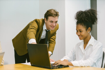 Obraz premium Diverse colleagues gather in brainstorm discuss statistics together. Group of people colleagues gather doing Brainstorming business plan together. Team Brainstorm Working Concept.