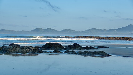 Sunrise on the beach in Tamarindo, Costa Rica, with mountains in the distance