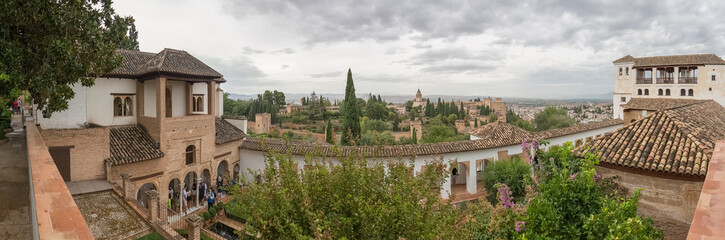 Fototapeta na wymiar Panoramic view at the Garden Water Channel, or Patio de la Acequia, Generalife Gardens, Alhambra citadel as background, Granada, Spain