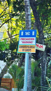 Sign warning of rip tides on the beach in Tamarindo, Costa Rica