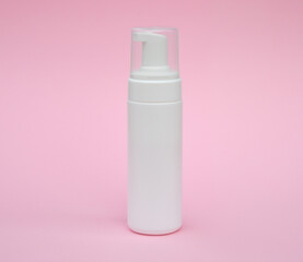 Empty white packaging tube for beauty spa, medical skin care and cosmetic lotion cream packaging, face wash foam, product design layout on pink background