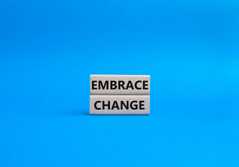 Embrace change symbol. Concept word Embrace change on wooden blocks. Beautiful blue background. Business and Embrace change concept. Copy space