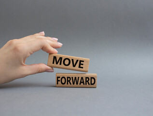 Move forward symbol. Wooden blocks with words Move forward. Beautiful grey background. Businessman hand. Business and Move forward concept. Copy space.