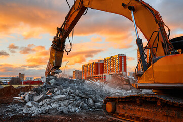 Excavator with concrete crusher on rig at demolition site - obrazy, fototapety, plakaty