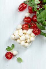 Mozzarella cheese with basil and tomatoes.