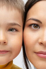 half face of son and mother close up. two halves of the face of the parent and child, similar eyes....