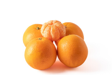 peeled tangerine on four oranges isolated on white background