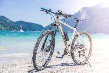 Naklejka na ściany i meble The bike stands against the backdrop of mountains and a lake