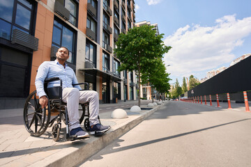 Serious wheelchair-bound person attempting to cross street