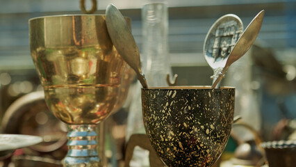 Old goblet with three tablespoons inside - obrazy, fototapety, plakaty
