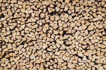 The texture of chopped firewood in a pallet.. Wooden background..