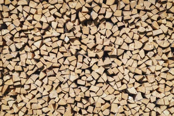 The texture of chopped firewood in a pallet.. Wooden background..