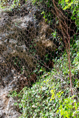 A protective metal mesh covers the rocks from rockfall