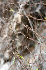 A protective metal mesh covers the rocks from rockfall