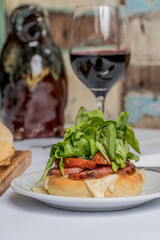 provolone with tomato and arugula and red wine