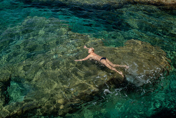 woman swims in clear water