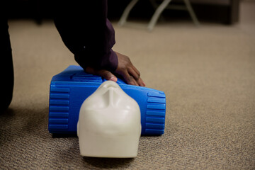 Security guard conducting CPR first aid with the AED.