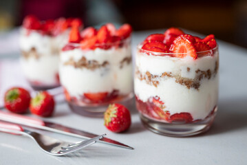 delicious homemade dessert with cream and strawberries in a glass