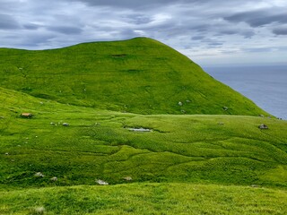 Fototapeta na wymiar landscape with green grass and cloudy sky, Kalsoy island, Faroe 