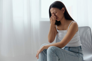 Fototapeta premium Rhinitis Sinusitis Flu. Suffering tormented tanned beautiful young Asian woman hold hand on nose bridge posing isolated on white background. Injuries Poor health Illness concept. Cool offer