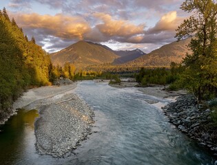 Picture of the Chilliwack river and surrounding mountains in beautiful evening light taken from the Vedder bridge in Chilliwack British Columbia Canada - obrazy, fototapety, plakaty