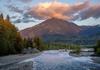 Picture of the Chilliwack river and surrounding mountains in beautiful evening light taken from the Vedder bridge in Chilliwack British Columbia Canada