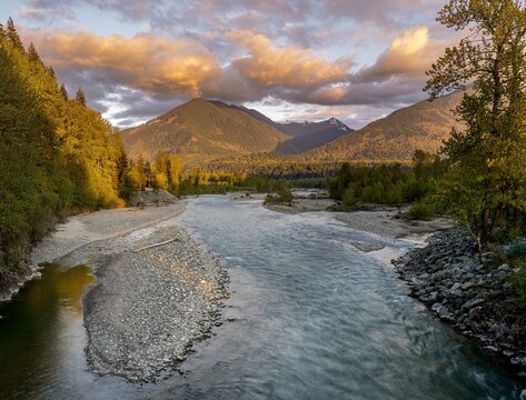 Picture of the Chilliwack river and surrounding mountains in beautiful evening light taken from the Vedder bridge in Chilliwack British Columbia Canada