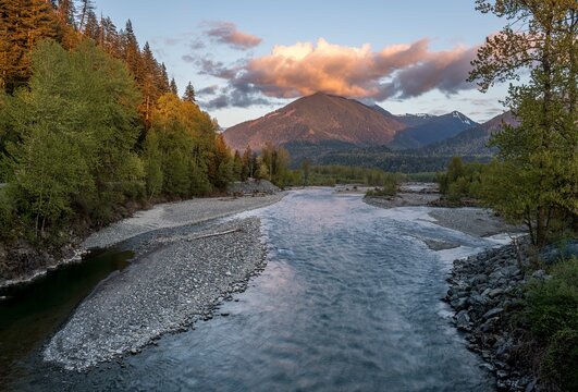 Picture of the Chilliwack river and surrounding mountains in beautiful evening light taken from the Vedder bridge in Chilliwack British Columbia Canada